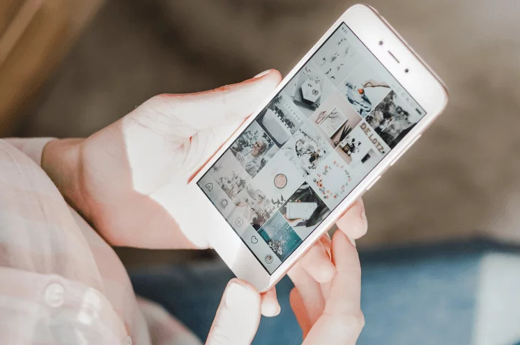 Instagram influencers: Une personne tenant un smartphone affichant une photo.